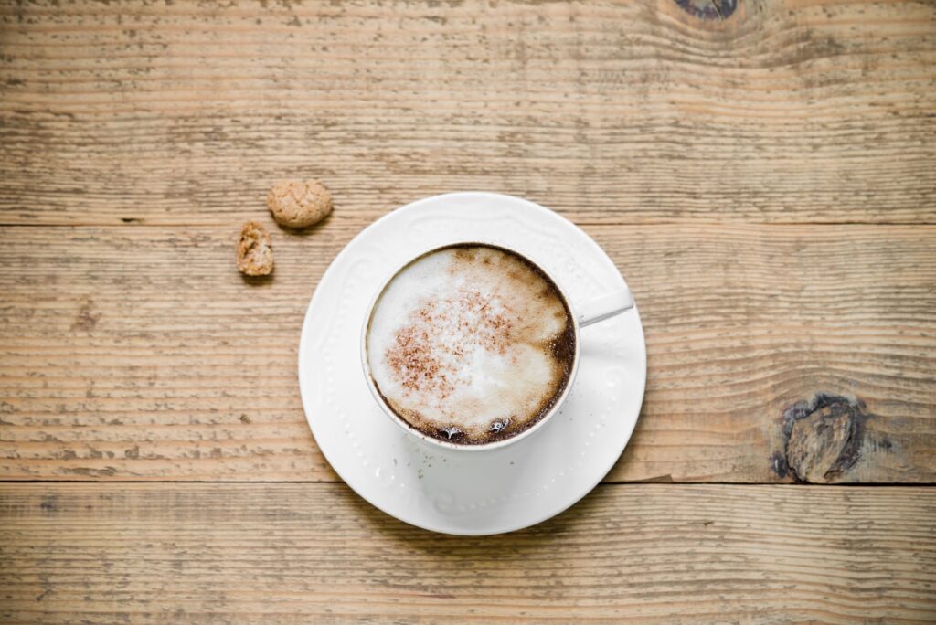 Cappuccino with biscotti on table
