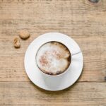 Cappuccino with biscotti on table