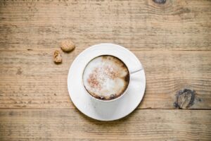 Cappuccino with biscotti on table